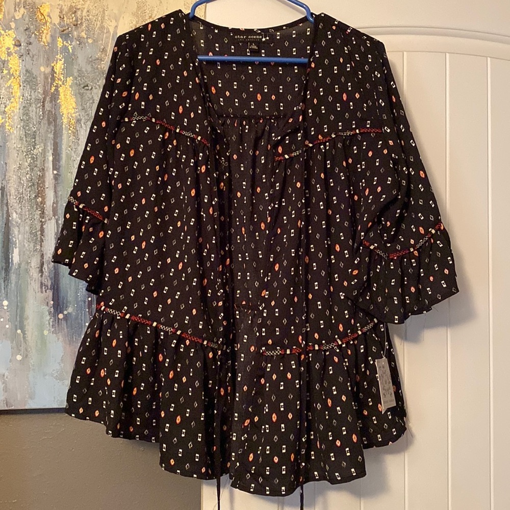Very cute shirt with it open in the front. You can wear a white tank top under